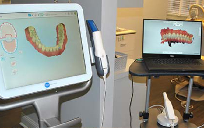 A dentist's office with a computer and a laptop.