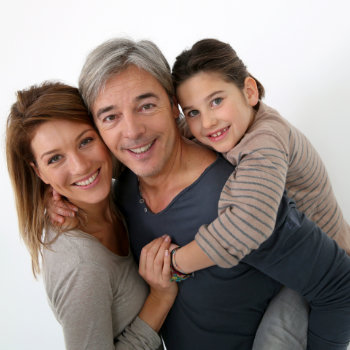 Happy family of three standing on a white background