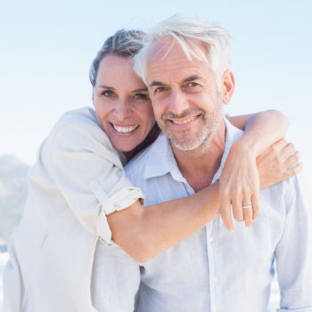 Mature couple laughing together and embracing